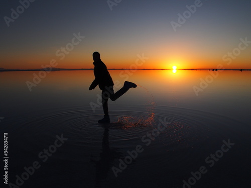 Man on the sunrise, Uyuni Salt Flat, Salar de Uyuni, Bolivia. Copy space for text