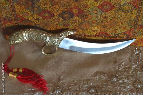  Arabic knife in Indian tablecloth and leather book