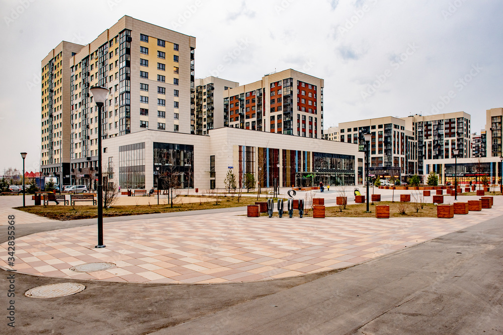 Fototapeta premium Modern multi-storey building in a new district of Moscow on a spring day