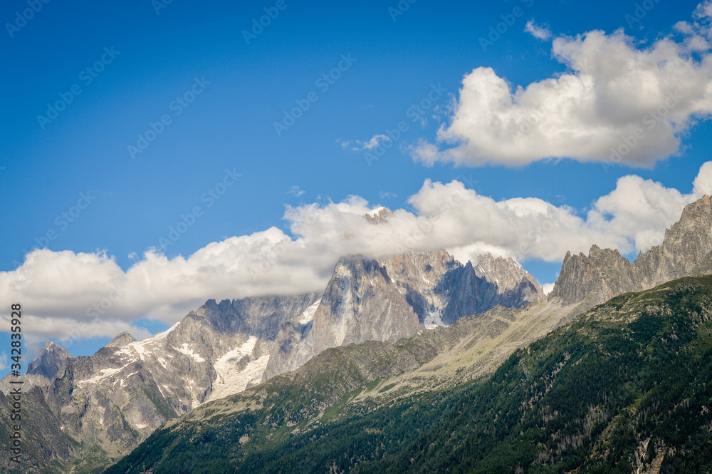 French Alps mountains in a cloudy summer day, seen from Les Houches near Chamonix, Haute Savoy, France.