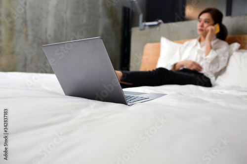 woman work from home on the bed
