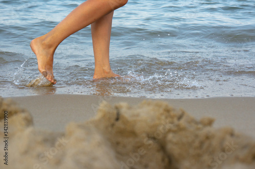 Men feet on the sand. Walking near the surf line. © Vitaly