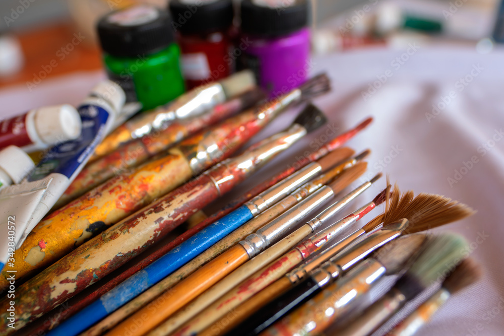 Fototapeta premium Paintbrush placed on a white cloth, Art Education, Learning to the 21st century, Stem studies.Selectively focus on specific points and blur in the image.