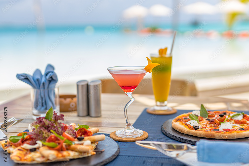 Pizza and tropical cocktail with beautiful sunny vacation infinity
