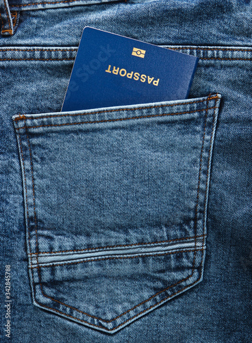 Passport in the back pocket of blue jeans. Traveled concept or immigration.