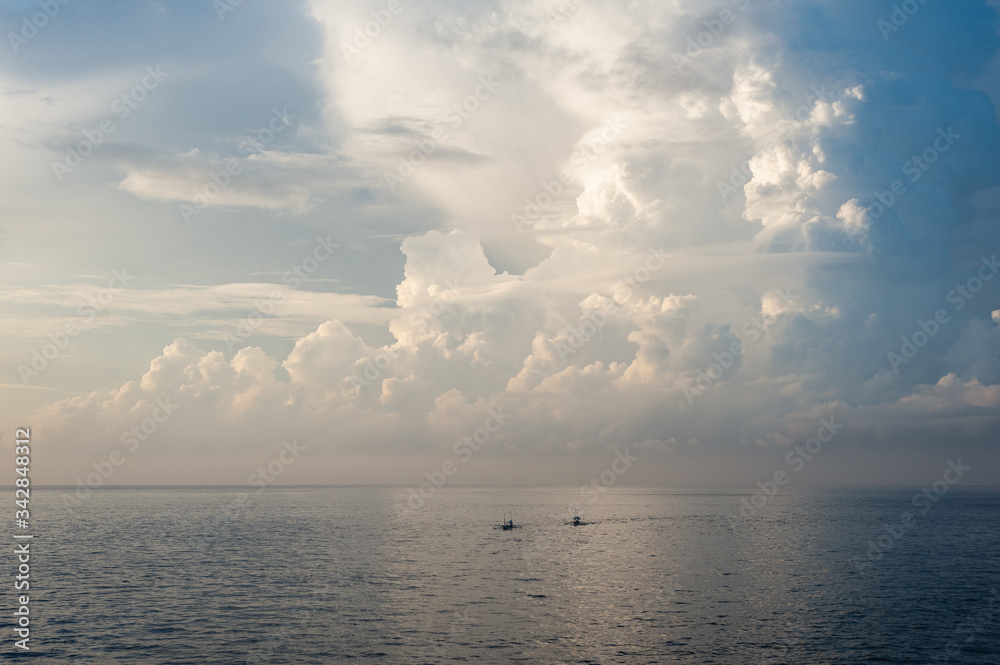 Large white cumulus clouds against a blue sky.