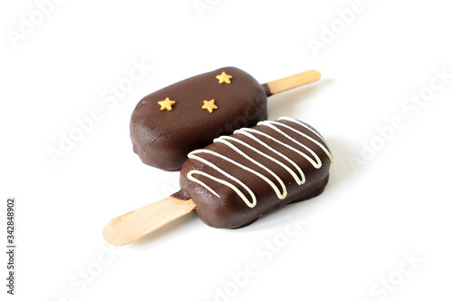 Two ice cream on a stick coated with chocolate. Isolated on a white background.