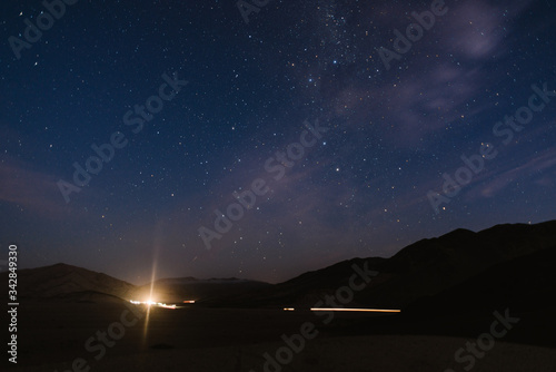 Timelapse clouds and stars over the cars / road