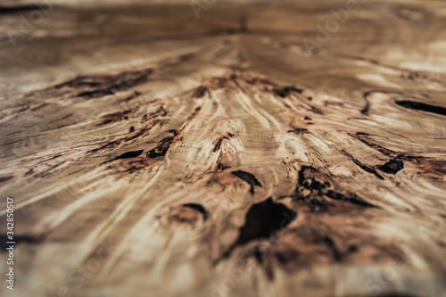 Wood surface cross section of elm tree. Live slab texture. Solid elm wooden table with epoxy resin filling. Wood countertop. Woodworking, carpentry, furniture production. Shallow depth of field.