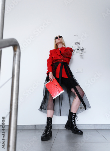 Girl model in a stylish bow. Black and red clothes, street style fashion.