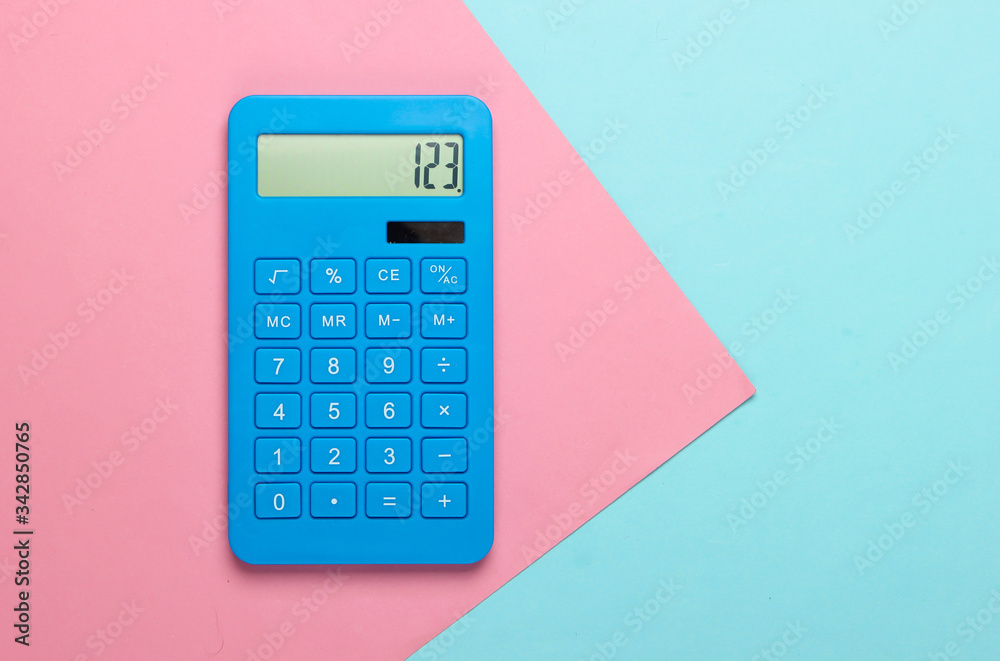 Blue calculator on pink blue pastel background. Calculation or counting. Copy space. Minimalism. Top view