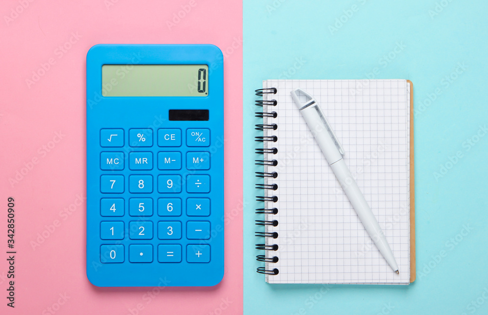 Calculator with a notebook on a blue-pink pastel background. Education process. Top view. Flat lay Calculator with a notebook on a blue-pink pastel background. Education process. Top view. Flat lay