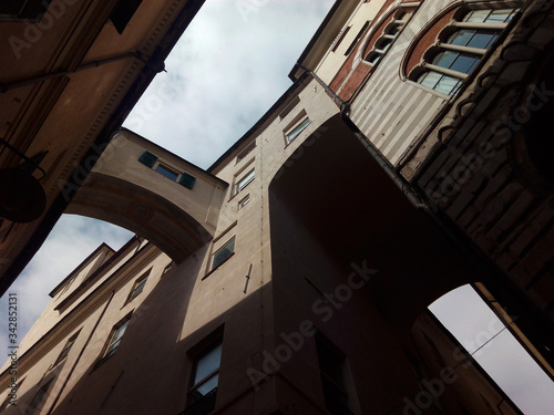 Shape looking the sky formed by Baroque facades and bridges in the street. City of Genoa. Italy.  