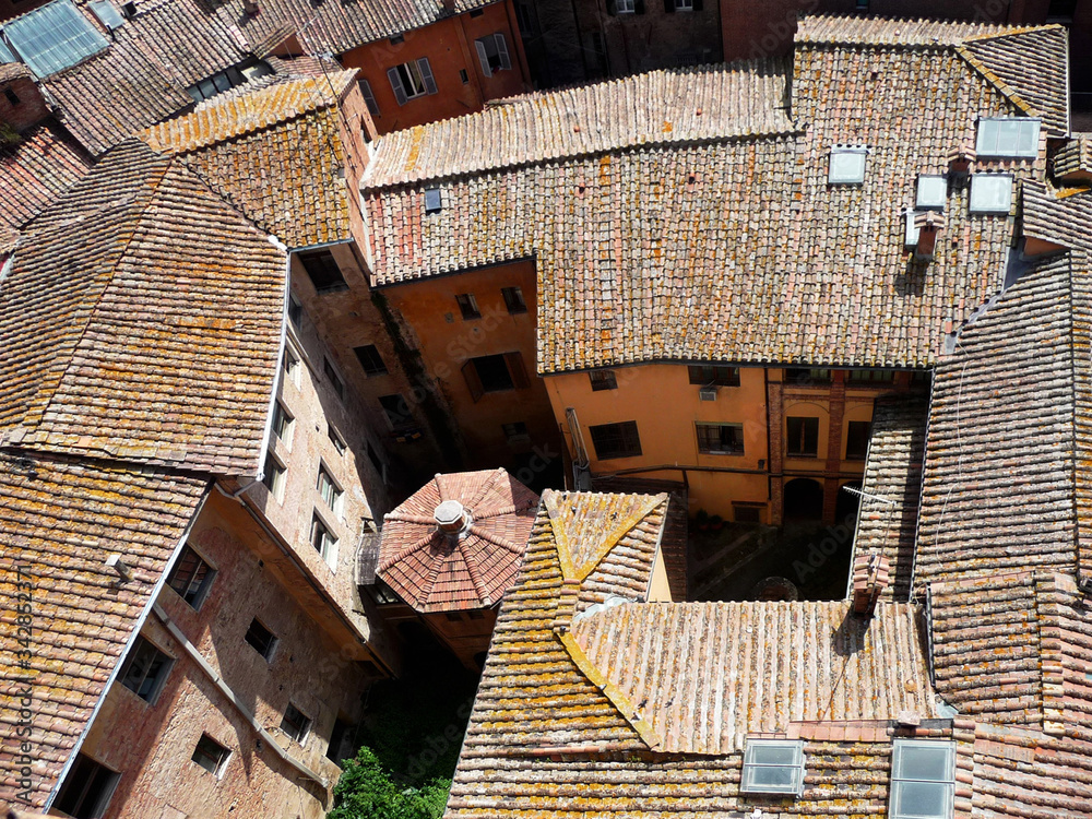 Aerial view on the tiled roofs of the historic city of Siena. Italy.