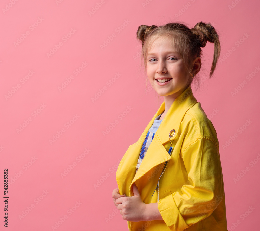 girl looking at camera smiling on pink background with copy space. studio shoot girl looking at camera smiling on pink background with copy space. studio shoot