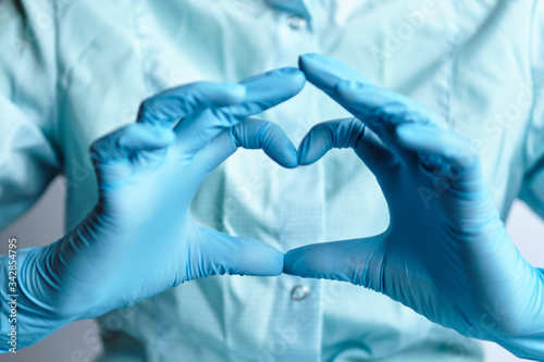 The abstract heart makes the doctor's hand in medical gloves.