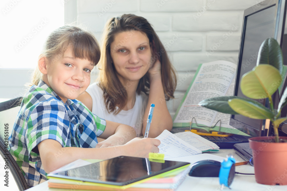tutor helps the student with homework on the computer tutor helps the student with homework on the computer