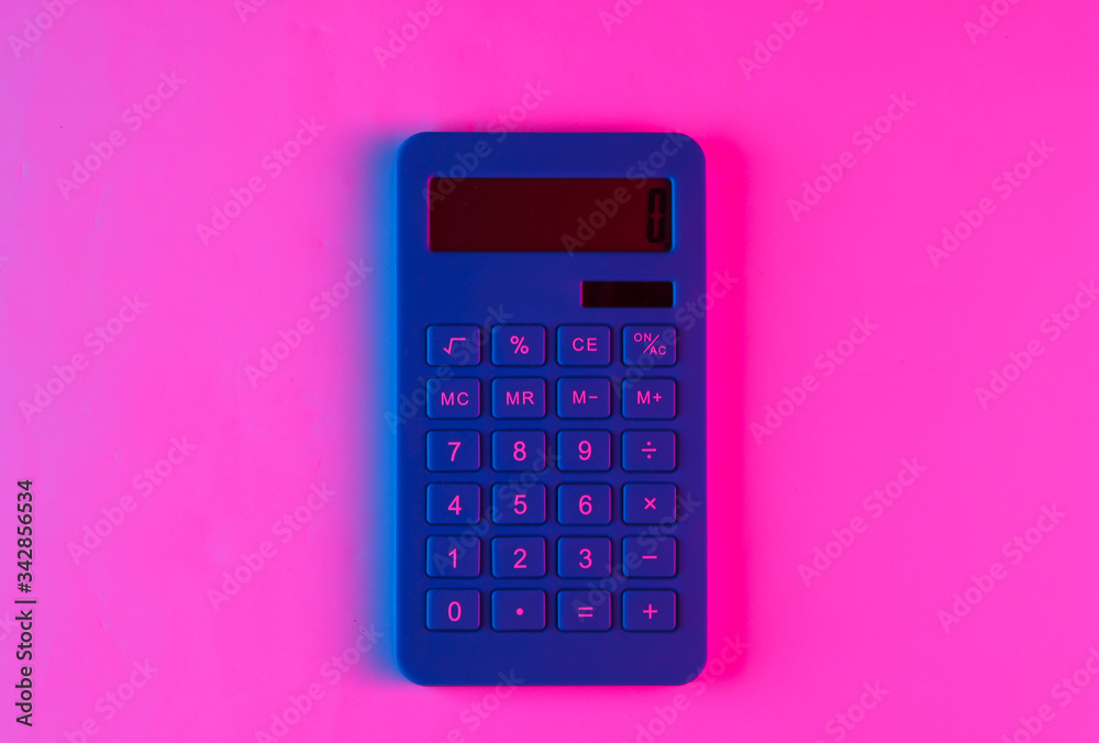 Calculator with neon blue pink gradient light. Top view Calculator with neon blue pink gradient light. Top view