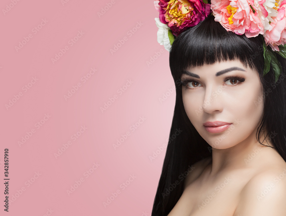 Naklejka premium Portrait of a beautiful happy woman with beautiful long hair and makeup. She has a wreath of flowers on her head. Cosmetology skin care and makeup.