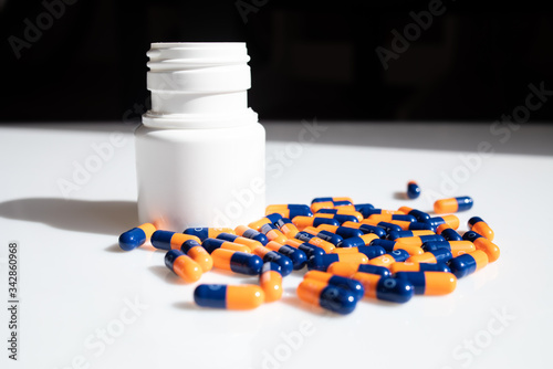 
orange and blue pills on a white backgroun