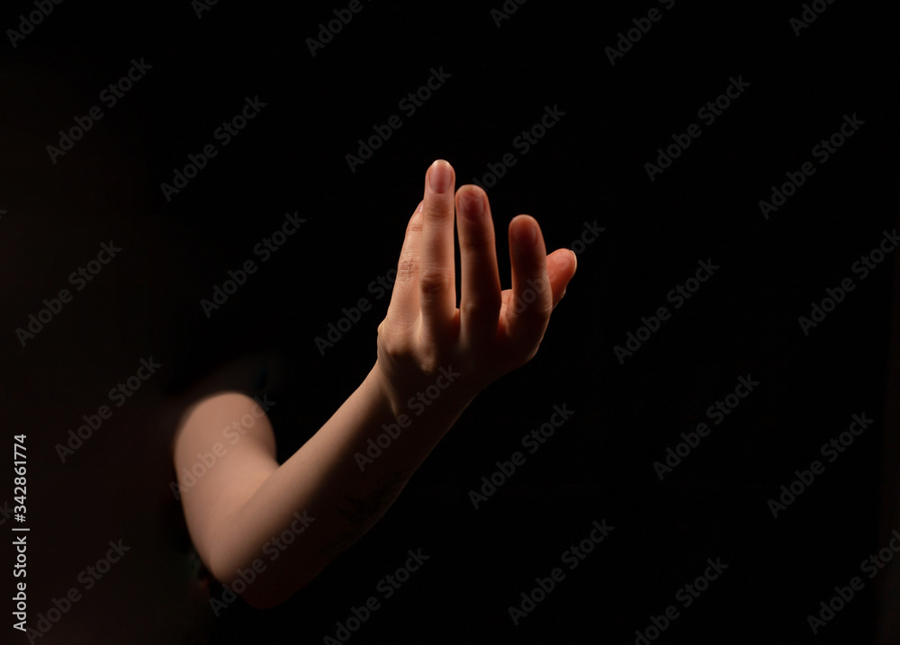 Woman hand on black background. Holding or offering. Outstretched female hand, girl keeping empty palm on black isolated background Woman hand on black background. Holding or offering. Outstretched female hand, girl keeping empty palm on black isolated background
