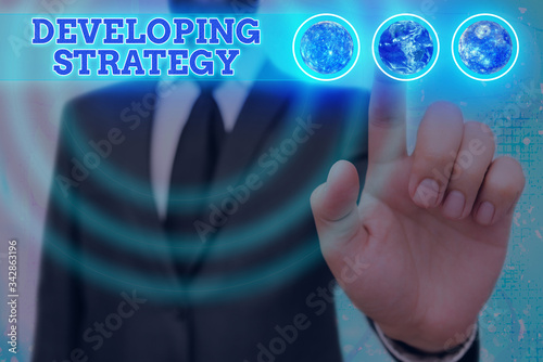 Word writing text Developing Strategy. Business photo showcasing Organizations Process Changes to reach Objectives Elements of this image furnished by NASA photo