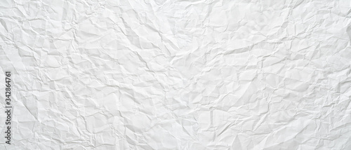 Texture of a white crumpled sheet of paper as a background