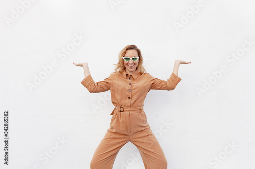 A young woman in a strange funny pose on a white background