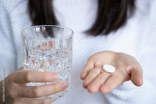 person with medical pill and a glass of water