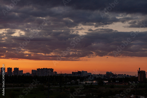 Sunset over the city. Sunset sky with beautiful clouds