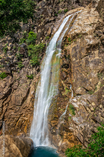 Amazing Rainbow waterfall with crystal clear blue coloured natural swimming pool at the bottom. Found ahead Nongriat village during winter trek to double decker living root bridge in Meghalaya  India.