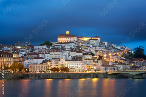 Coimbra city view at night with Mondego river and beautiful historic buildings, in Portugal