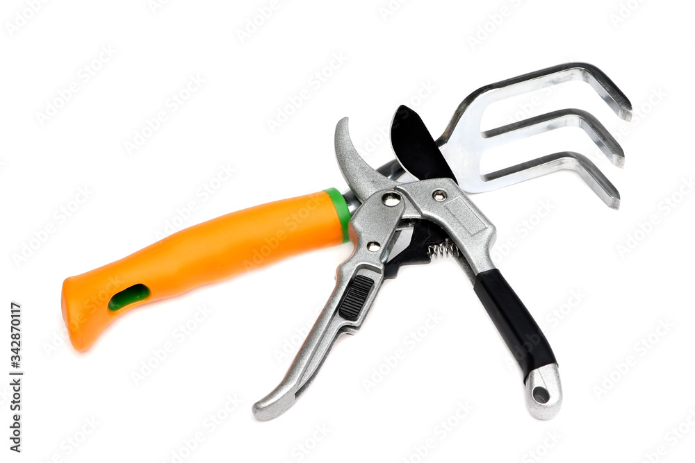Scissors for pruning branches and garden rake isolated on a white background. Secateurs. Gardening tools Scissors for pruning branches and garden rake isolated on a white background. Secateurs. Gardening tools