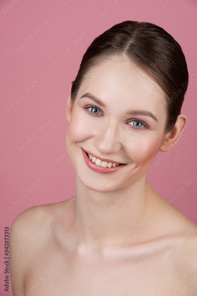 Portrait of a beautiful girl with natural make-up holding a flower in her hand. Portrait of a beautiful girl with natural make-up holding a flower in her hand.