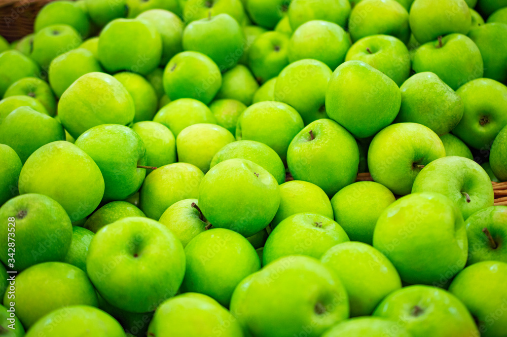 green golden apples on the supermarket counter background green golden apples on the supermarket counter background