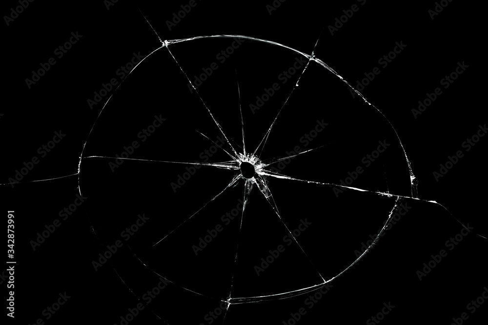 Broken glass texture with hole in center isolated on black background