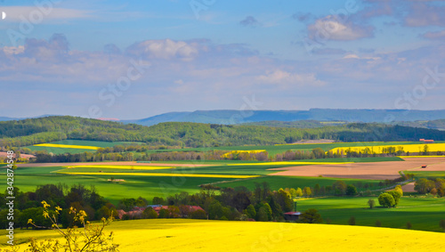 A beautiful german agriculture landscape with light and yellow rape fields