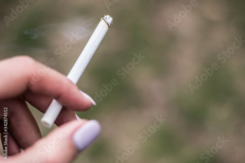 Cigarette in the woman hand. Smoking - Activity, Tobacco Product