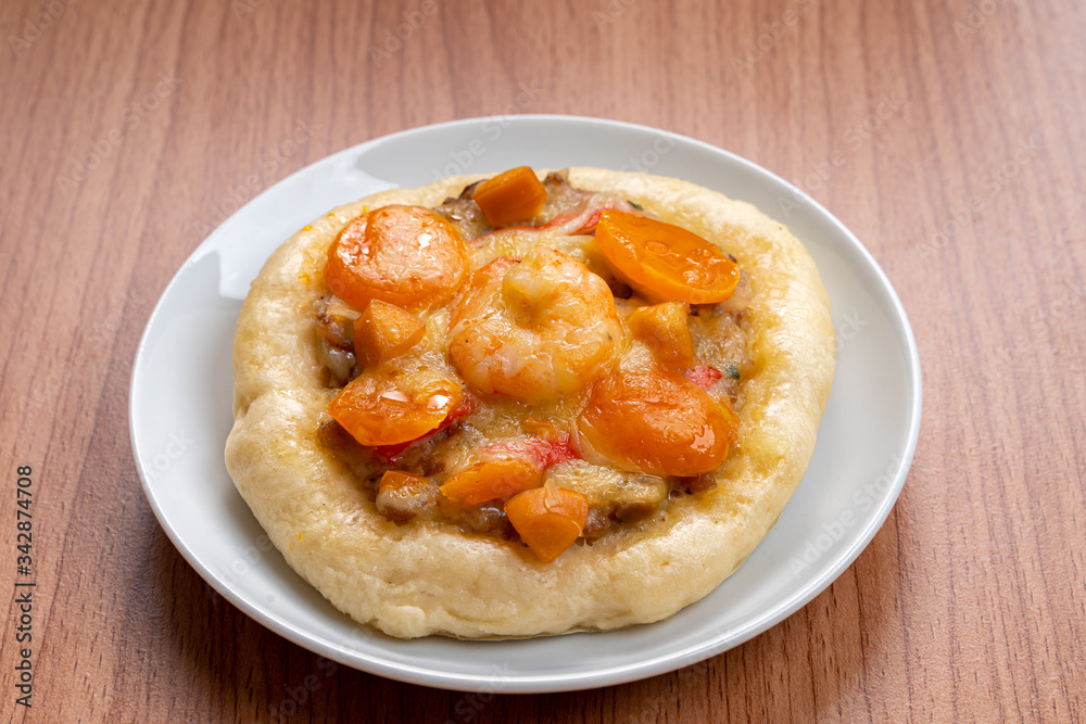 Pizza Cheese with Shrimp, Pork, Imitation Crab Stick and Salted Eggs on White Dish Wood Table.