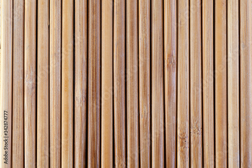 Japanese wooden chopsticks folded together form a continuous background . View from above.