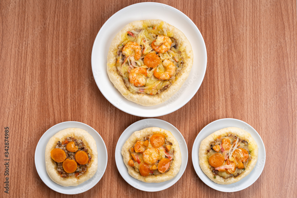 Pizza Cheese with Shrimp, Pork, Imitation Crab Stick and Salted Eggs on White Dish Wood Table. Pizza Cheese with Shrimp, Pork, Imitation Crab Stick and Salted Eggs on White Dish Wood Table.
