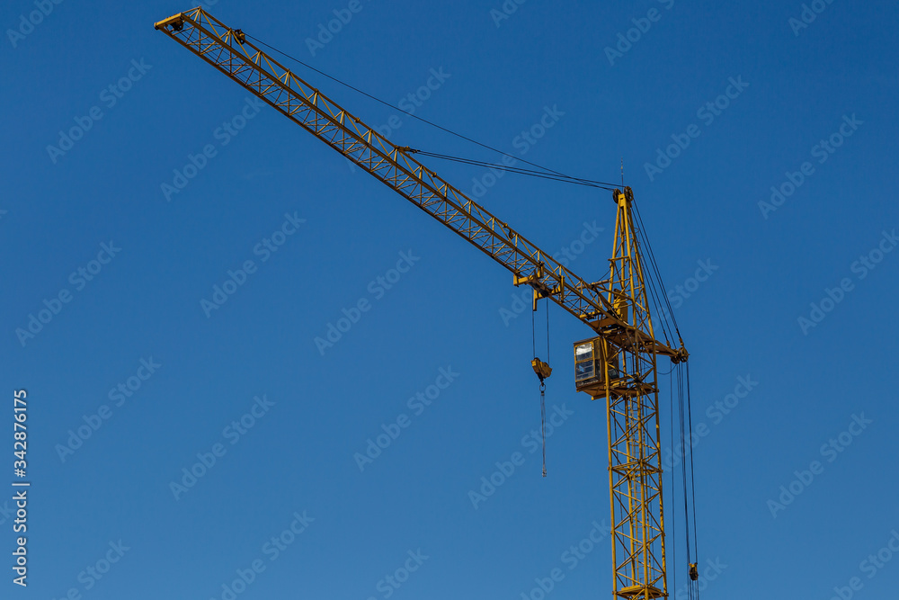 Extensive scaffolding providing platforms for work in progress on a new apartment block,Tall building under construction with scaffolds,Freestanding tower crane on a building site Extensive scaffolding providing platforms for work in progress on a new apartment block,Tall building under construction with scaffolds,Freestanding tower crane on a building site