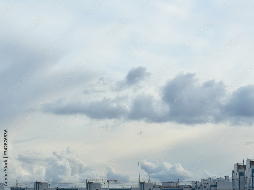 gray clouds in the sky over buildings of various shapes during the day