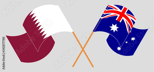 Crossed and waving flags of Australia and Qatar