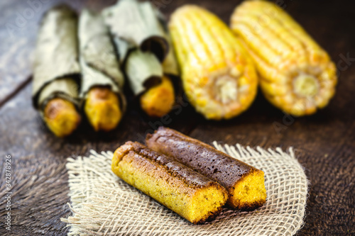 Broa made with corn and wrapped in banana leaf. Corn bread made for the June and July parties in Brazil. Brazilian cuisine. photo