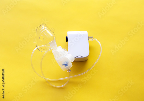 Inhaler on a yellow background. copy space. White inhaler for children and adults. Health problem. Respiratory disease