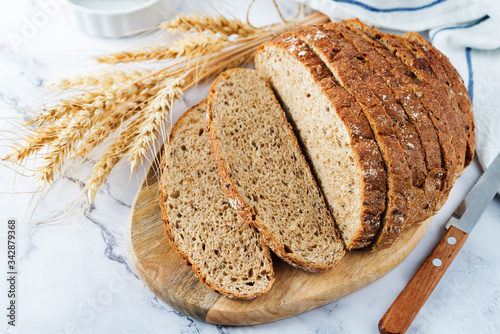 Fotografie, Obraz Wholegrain rye bread with glasses of milk