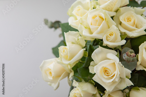 Close Up Of Little Bouquet Made Of White Rose Flowers On A White Paper Background With Copy Space