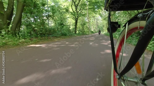 Riding Bike in Summer in Park City. The city courier service the courier rides a bicycle photo