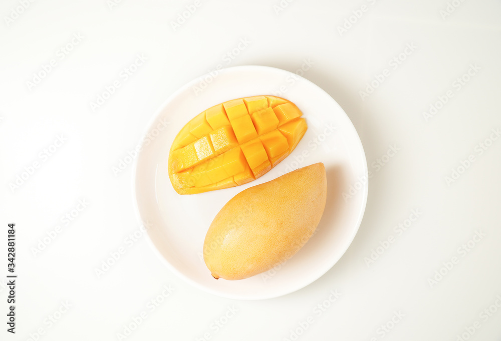 Fresh Mango on white plate and white background Fresh Mango on white plate and white background